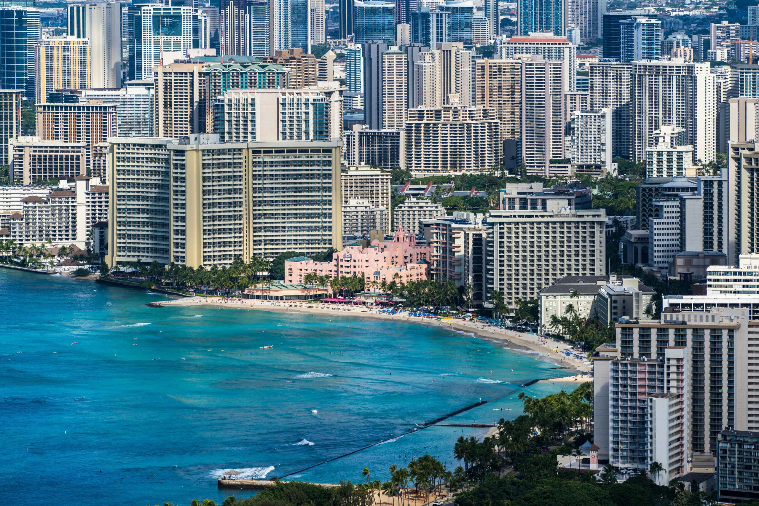 Explore Honolulu's stunning skyline and turquoise coastline in this captivating aerial shot.