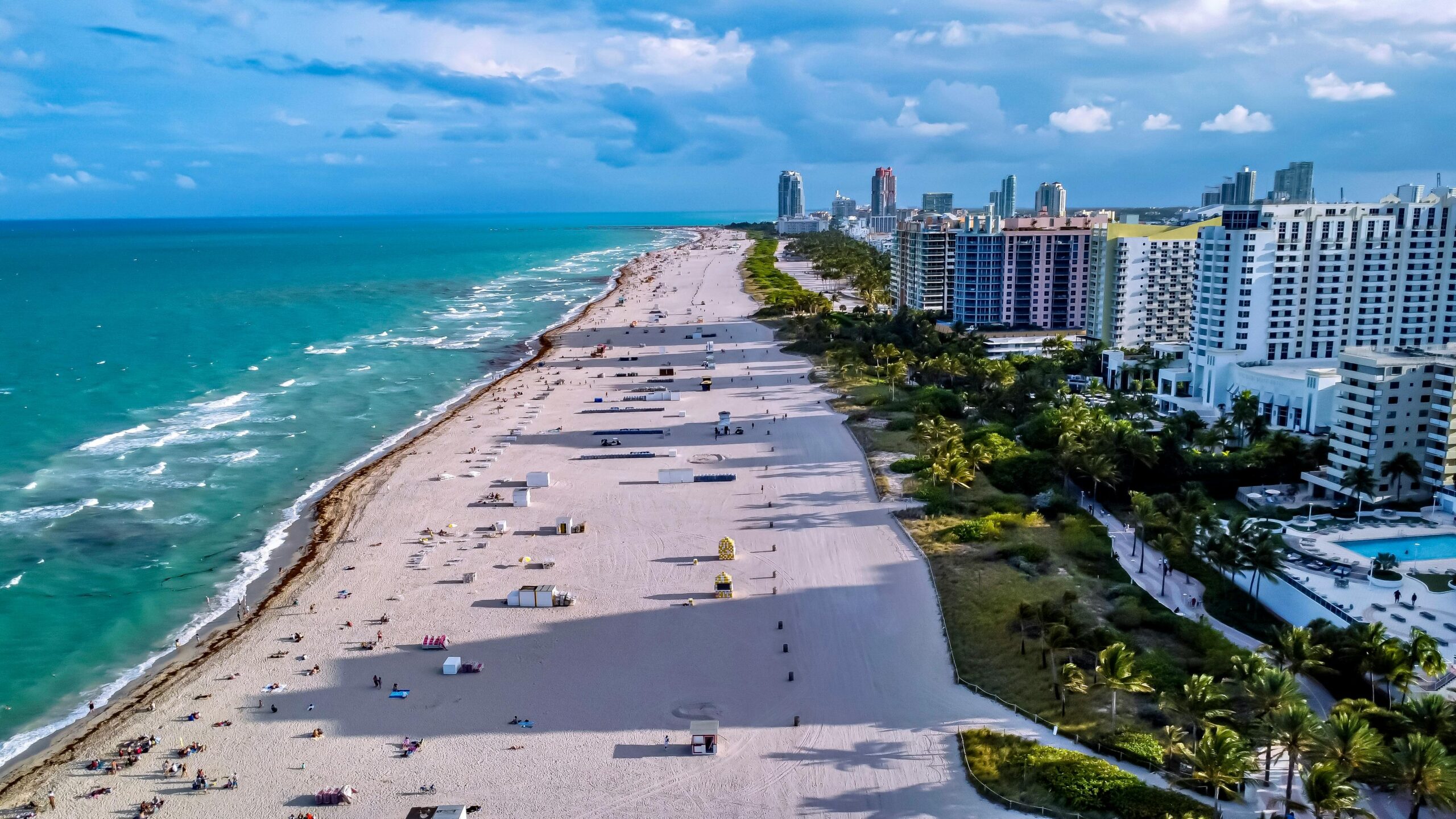 Aerial shot of Miami Beach showcasing the coastline, city skyline, and vibrant sea.